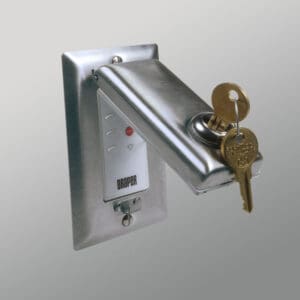 Wall-mounted key switch with Draper logo.