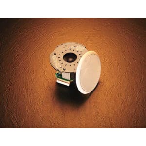 Ceiling speaker on textured brown surface.