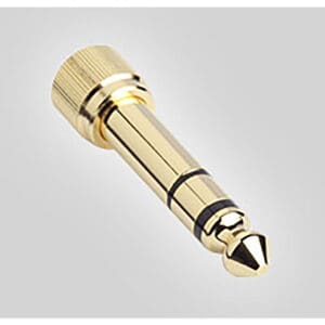 Gold audio jack adapter on gray background.