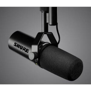 Black Shure microphone against a gray background.