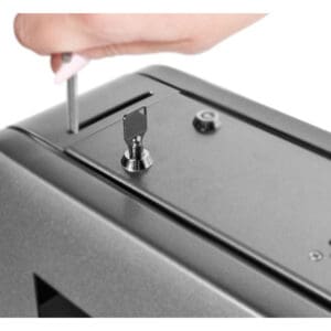 Hand using key on a lockbox.