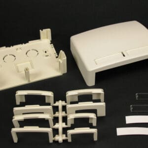 Disassembled beige plastic enclosure parts.
