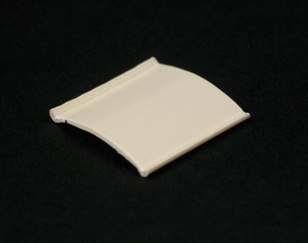 Off-white curved plastic piece.