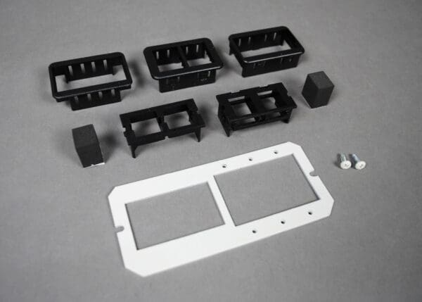 Black plastic switch plate kit and screws.