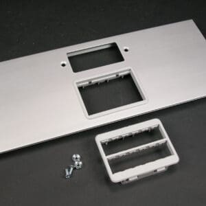 Silver metal faceplate with cutouts and screws.