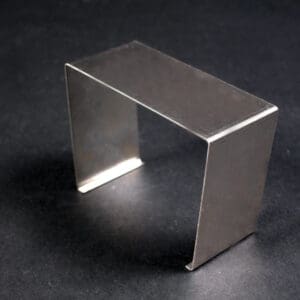 Metal square frame on dark surface.