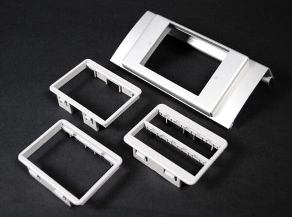 Here's an alt tag for the image: Grey plastic faceplate frames.