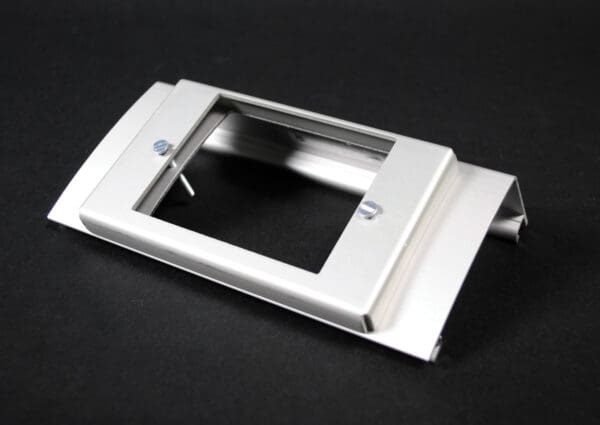 Here's an alt tag for the image: Silver metal wall plate with screws.