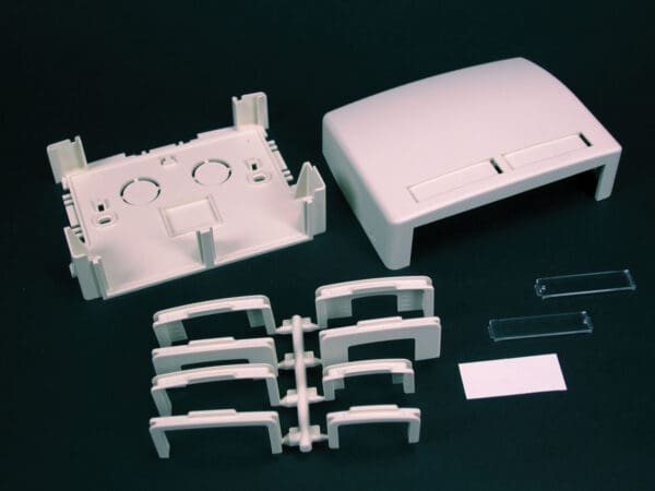 Disassembled plastic enclosure parts.