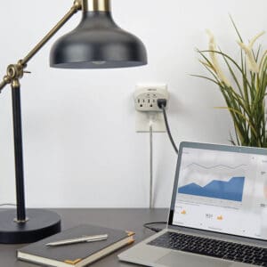 Surge protector with laptop and lamp.