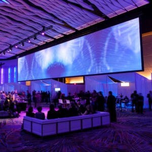 Large screen, event space, purple lighting.