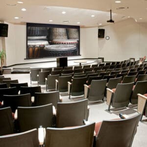 Auditorium with stage and drums projected.