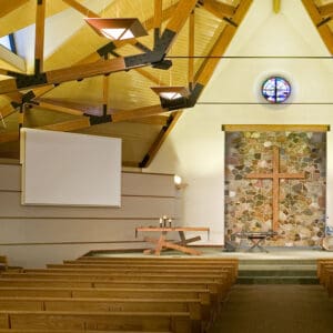 Modern church sanctuary with wooden cross.